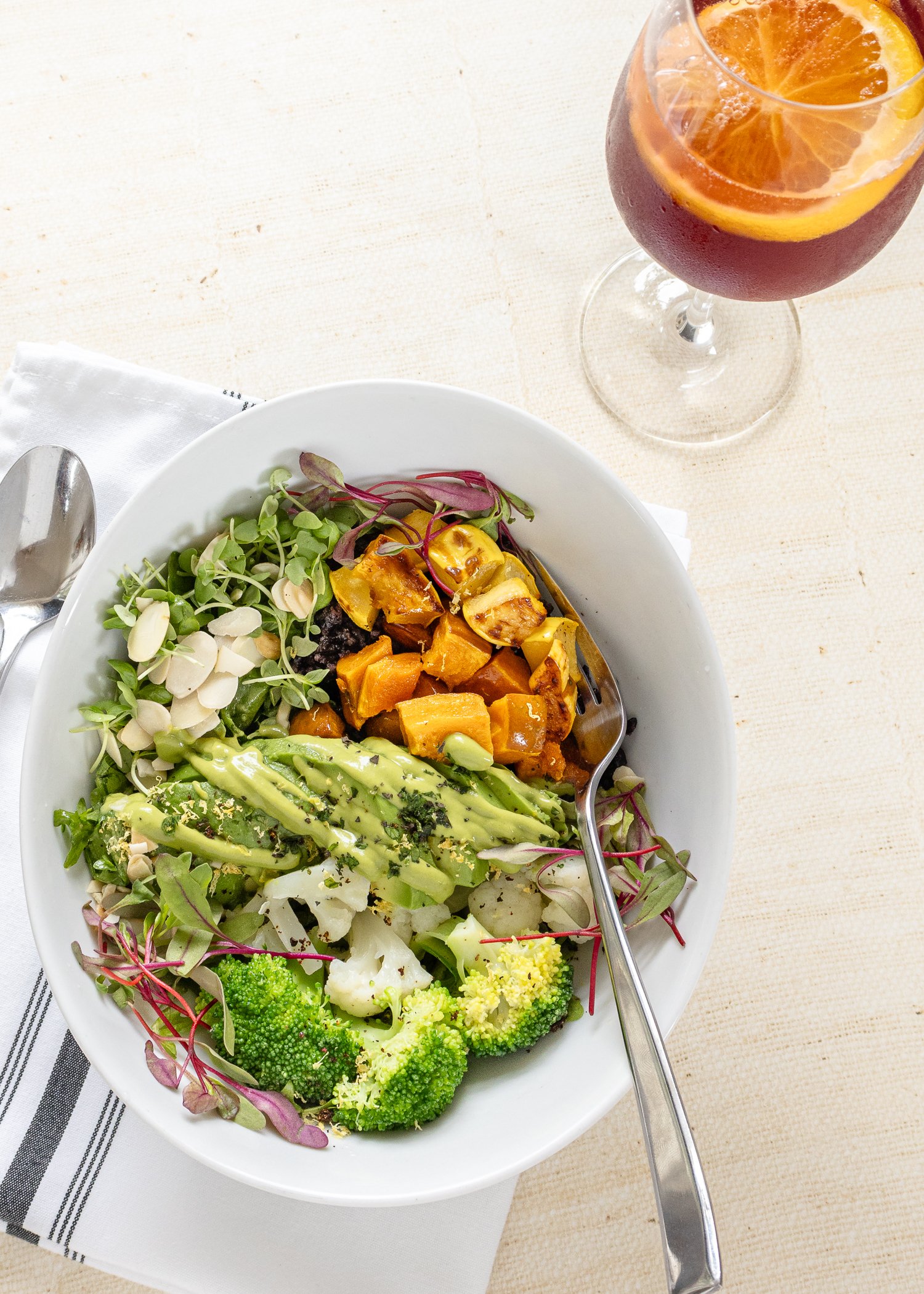 Harvest grain bowl with roasted squash, avocado, broccoli and microgreens